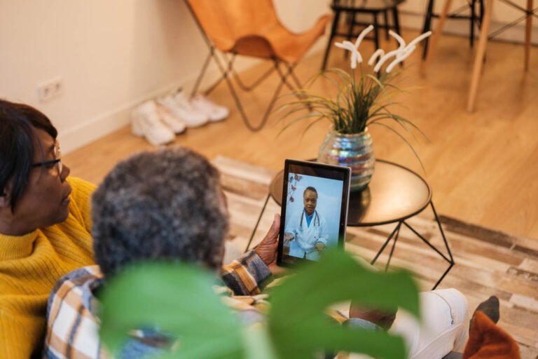 Solentra Wellness | Senior couple attended by the doctor through the tablet through